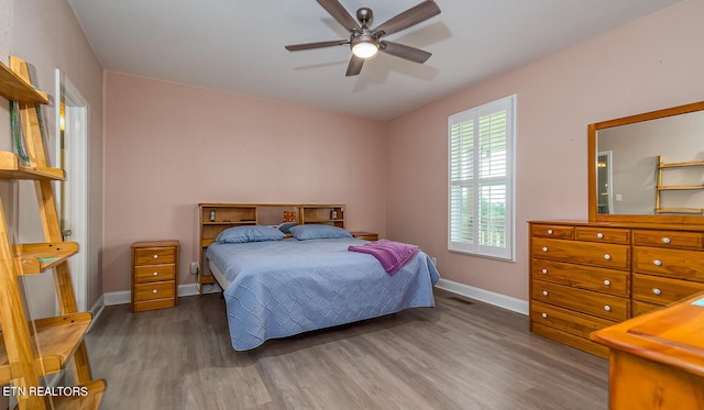 bedroom with wood-type flooring and ceiling fan