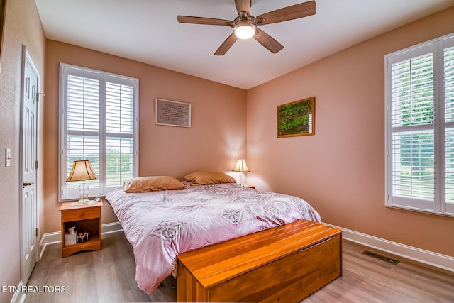 bedroom with ceiling fan and light hardwood / wood-style floors