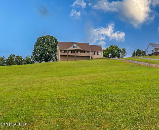 view of front of property featuring a deck and a front lawn