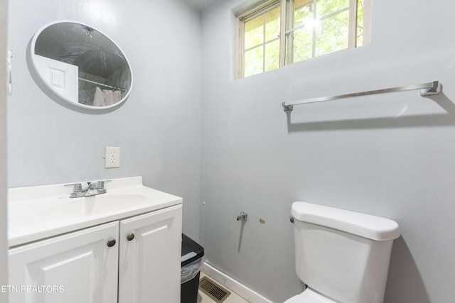 bathroom featuring vanity and toilet