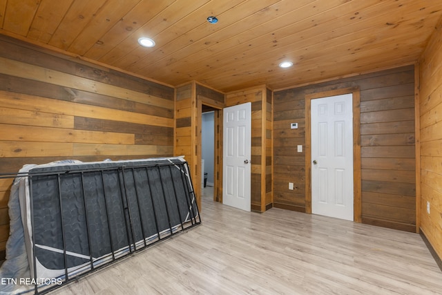 interior space with wood walls, wooden ceiling, and light wood-type flooring