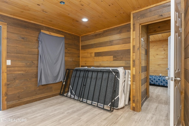 bedroom with wood ceiling, wood-type flooring, and wooden walls