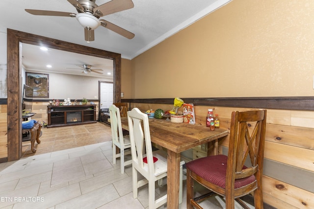 tiled dining room featuring ceiling fan and ornamental molding