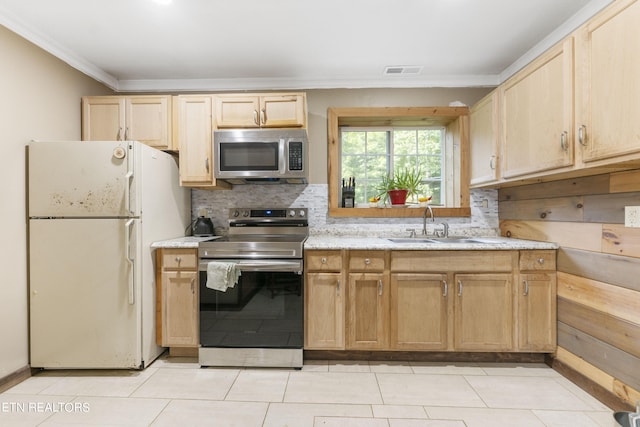 kitchen with light brown cabinets, sink, stainless steel appliances, and light tile patterned flooring