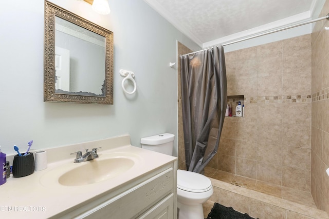 bathroom featuring ornamental molding, a textured ceiling, vanity, toilet, and curtained shower