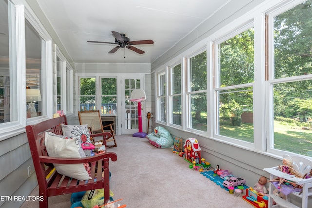 sunroom / solarium featuring ceiling fan