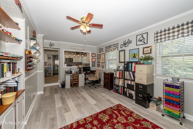 home office featuring ceiling fan, light hardwood / wood-style floors, and crown molding