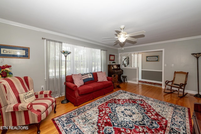 living room with ceiling fan, wood-type flooring, and ornamental molding