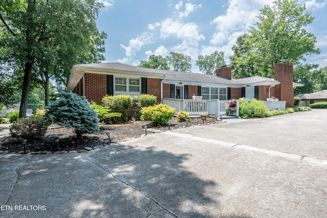 single story home with covered porch