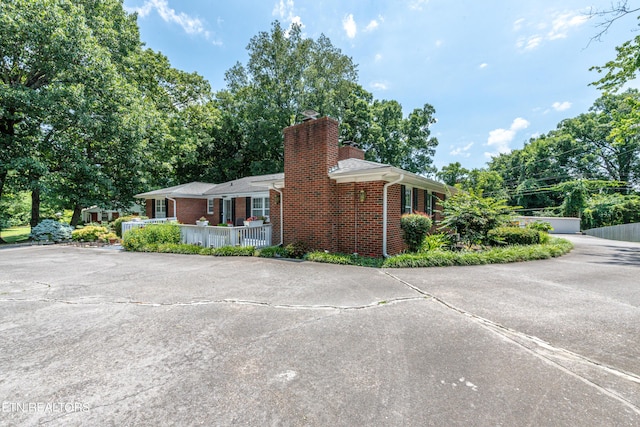 view of property exterior featuring covered porch