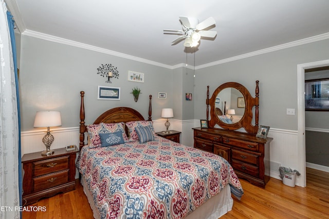 bedroom featuring ceiling fan, ornamental molding, and light hardwood / wood-style flooring