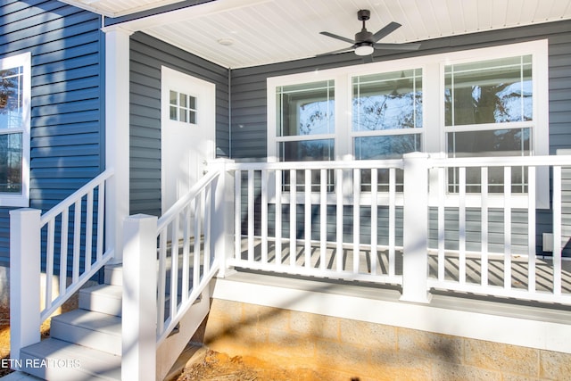 view of exterior entry featuring ceiling fan and a porch