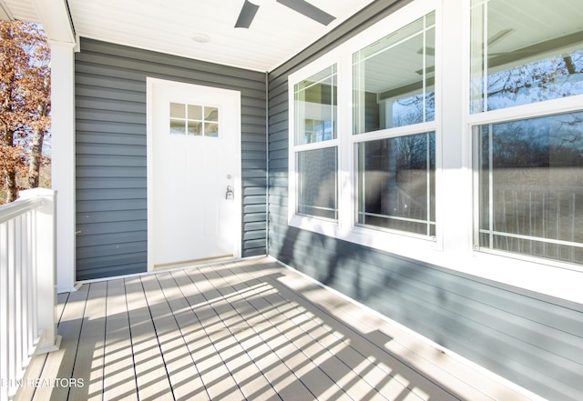 view of exterior entry featuring ceiling fan