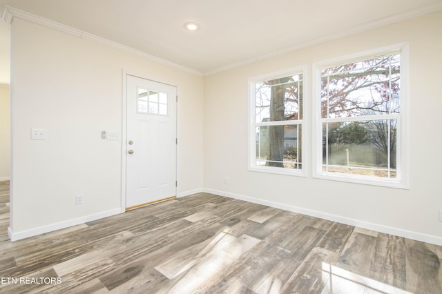 entrance foyer featuring ornamental molding and hardwood / wood-style floors