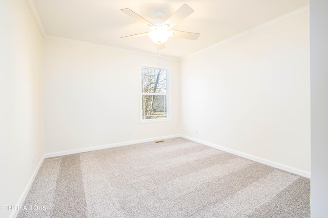 empty room with ceiling fan, carpet, and crown molding