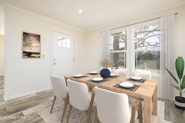 dining space featuring ornamental molding and hardwood / wood-style flooring