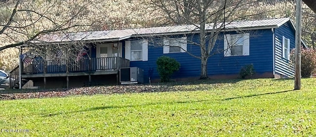 view of front of property with a deck and a front yard