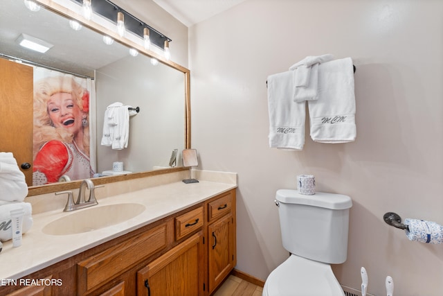 bathroom featuring vanity and toilet