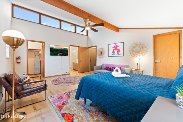 bedroom featuring ensuite bathroom, ceiling fan, light hardwood / wood-style floors, and lofted ceiling with beams