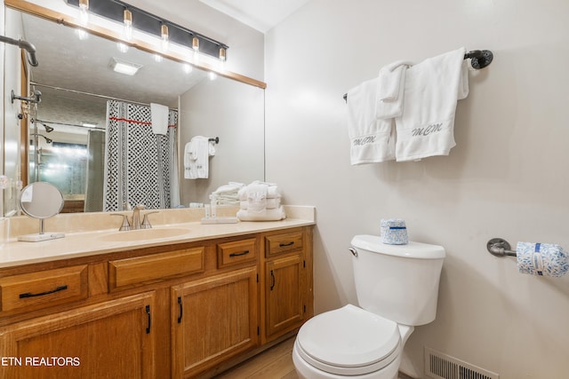 bathroom featuring a shower with curtain, vanity, and toilet