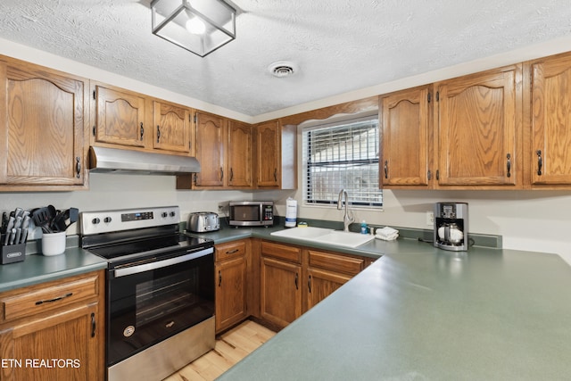 kitchen featuring sink, a textured ceiling, and appliances with stainless steel finishes