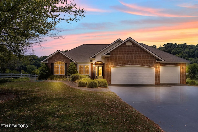 view of front facade with a lawn and a garage