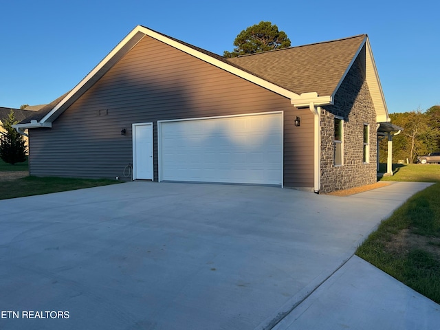 view of side of home with a garage