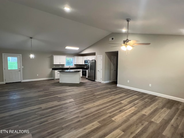 kitchen featuring white cabinetry, a healthy amount of sunlight, dark hardwood / wood-style floors, and stainless steel refrigerator with ice dispenser