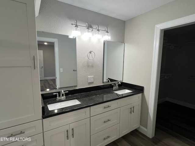 bathroom with vanity and wood-type flooring