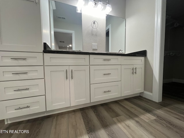 bathroom with vanity and hardwood / wood-style flooring