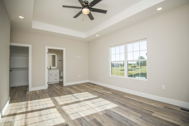 116 Duseth Dr, Sweetwater, TN 37874 - unfurnished bedroom featuring wood finished floors, a tray ceiling, recessed lighting, a walk in closet, and ensuite bathroom