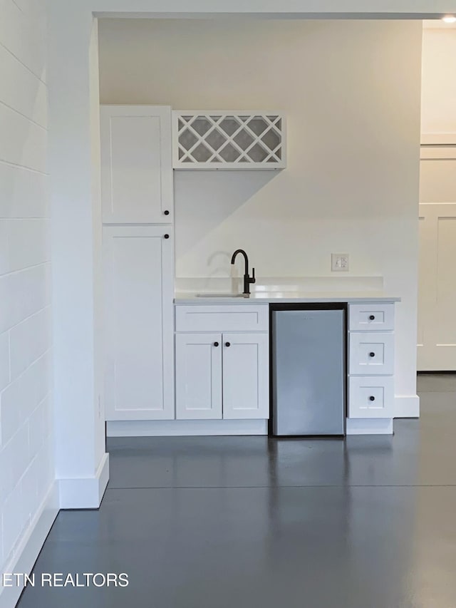 116 Duseth Dr, Sweetwater, TN 37874 - indoor wet bar with fridge and finished concrete floors