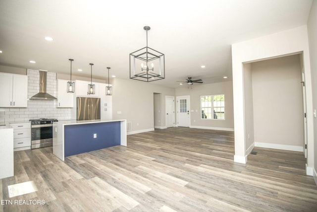 116 Duseth Dr, Sweetwater, TN 37874 - kitchen featuring wall chimney exhaust hood, stainless steel appliances, a center island, white cabinets, and light countertops