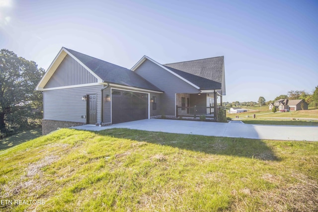 116 Duseth Dr, Sweetwater, TN 37874 - view of front of house with a porch, a garage, a front lawn, concrete driveway, and a shingled roof