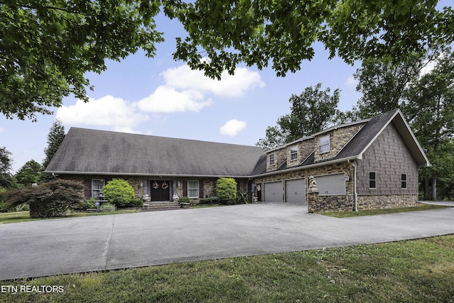 view of front facade with stone siding and concrete driveway