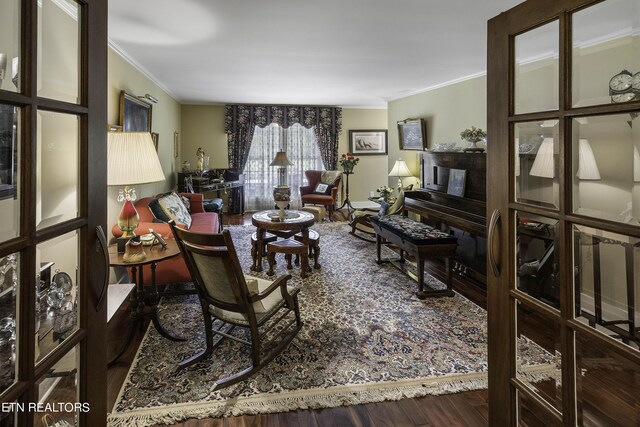 living room featuring ornamental molding and wood finished floors