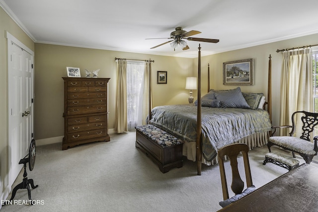 bedroom with baseboards, carpet floors, ornamental molding, a closet, and a ceiling fan