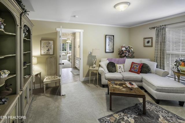 living room with baseboards, light colored carpet, and crown molding