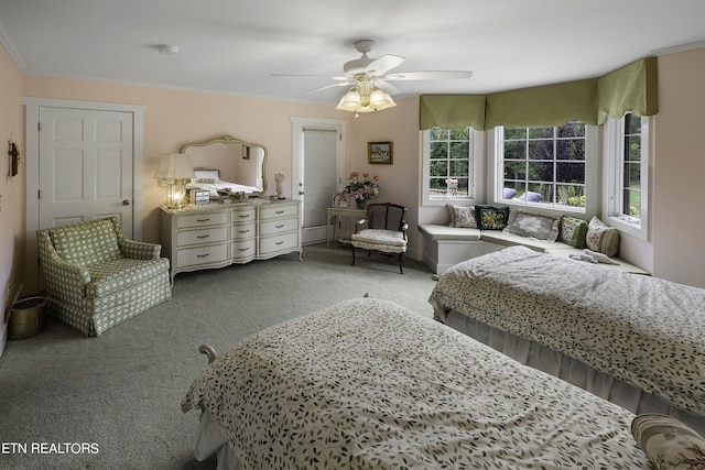 bedroom with carpet floors, ornamental molding, and a ceiling fan