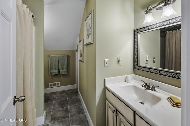 full bath with vanity, baseboards, visible vents, lofted ceiling, and tile patterned floors