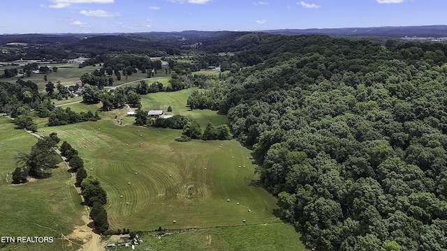 drone / aerial view with a wooded view