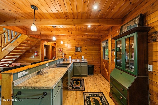 bar featuring light stone countertops, sink, hanging light fixtures, and wood walls