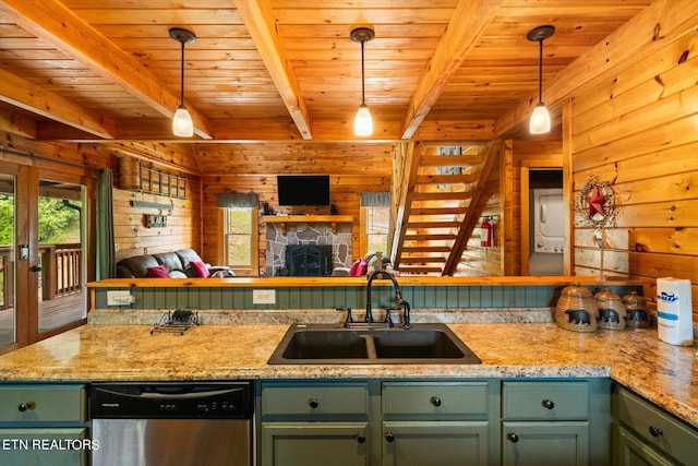 kitchen with wood walls, stainless steel dishwasher, hanging light fixtures, beam ceiling, and sink