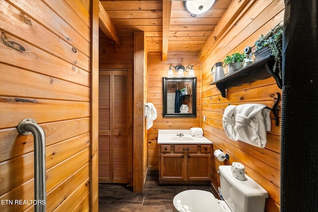 bathroom with vanity, wood walls, hardwood / wood-style floors, beamed ceiling, and wood ceiling