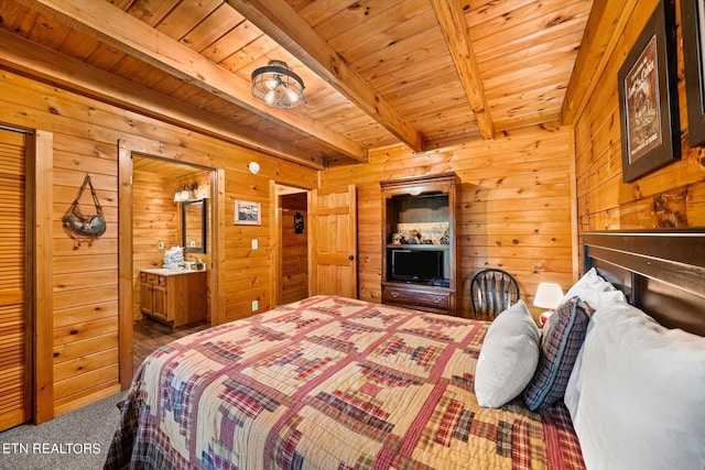 bedroom featuring beam ceiling, wooden walls, and wooden ceiling