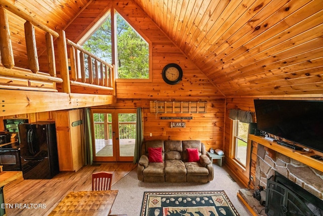 living room featuring french doors, wooden ceiling, a wealth of natural light, and wood walls