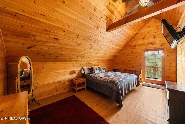 bedroom with vaulted ceiling with beams, wooden walls, light hardwood / wood-style floors, and wooden ceiling