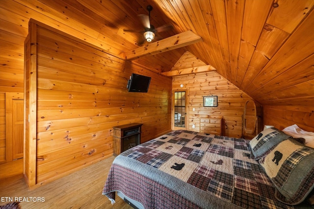 bedroom featuring light hardwood / wood-style floors, ceiling fan, wood ceiling, and vaulted ceiling with beams