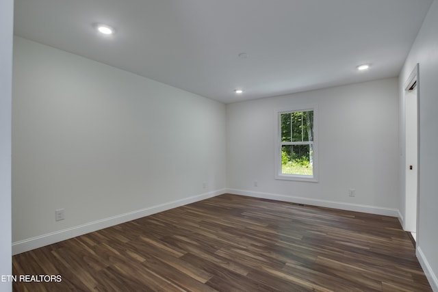 empty room with dark hardwood / wood-style floors