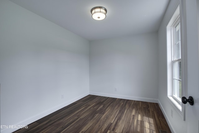 unfurnished room featuring dark hardwood / wood-style floors